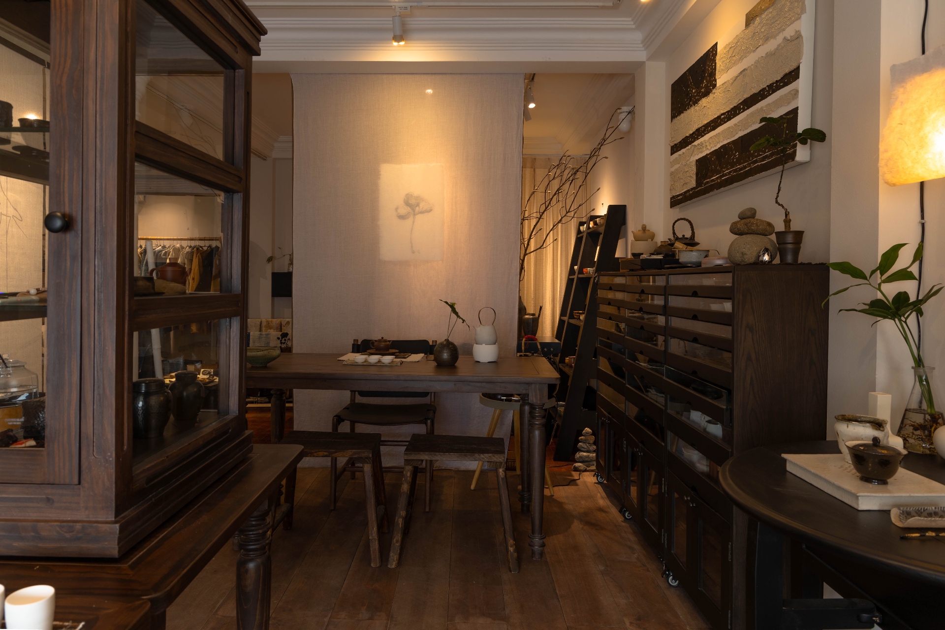 Still — gallery interior with handmade teapot on stone plinth